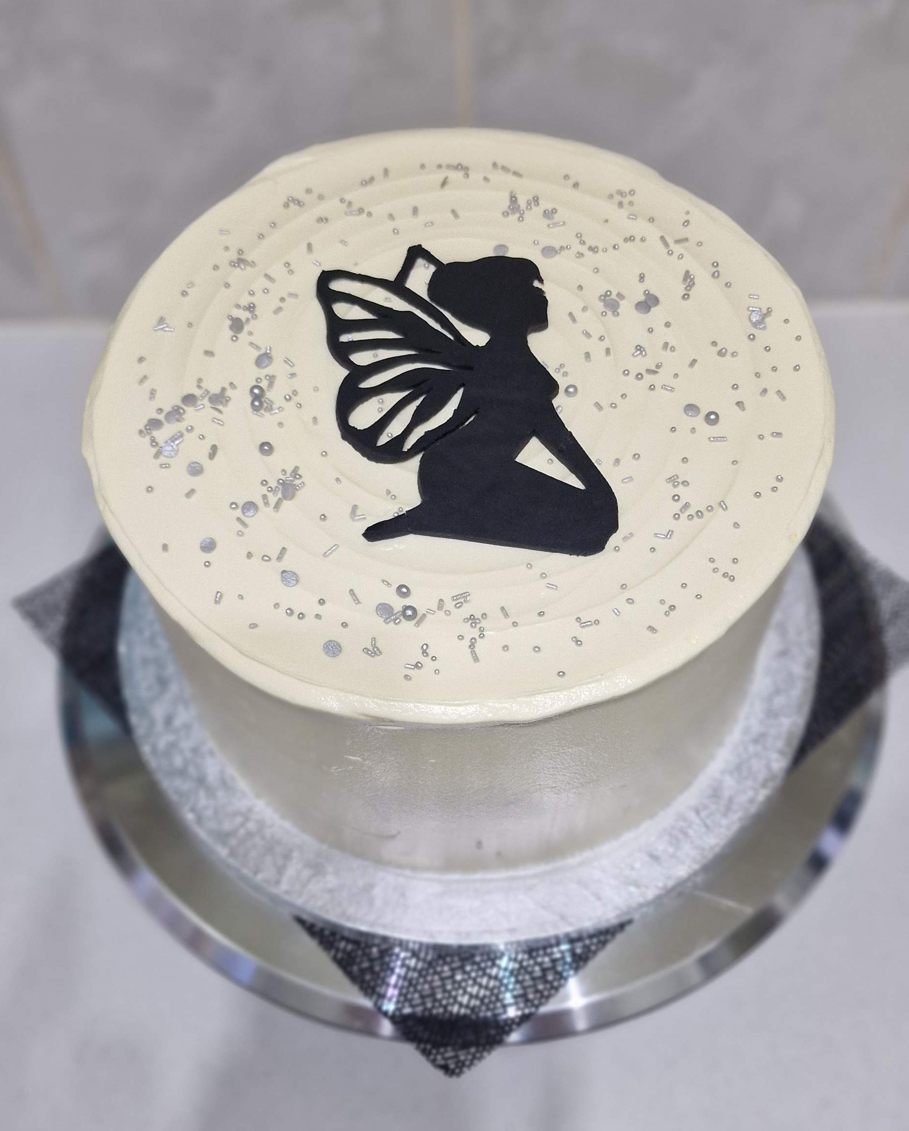Elegant white frosted custom silhouette fairy birthday cake with silver sprinkles