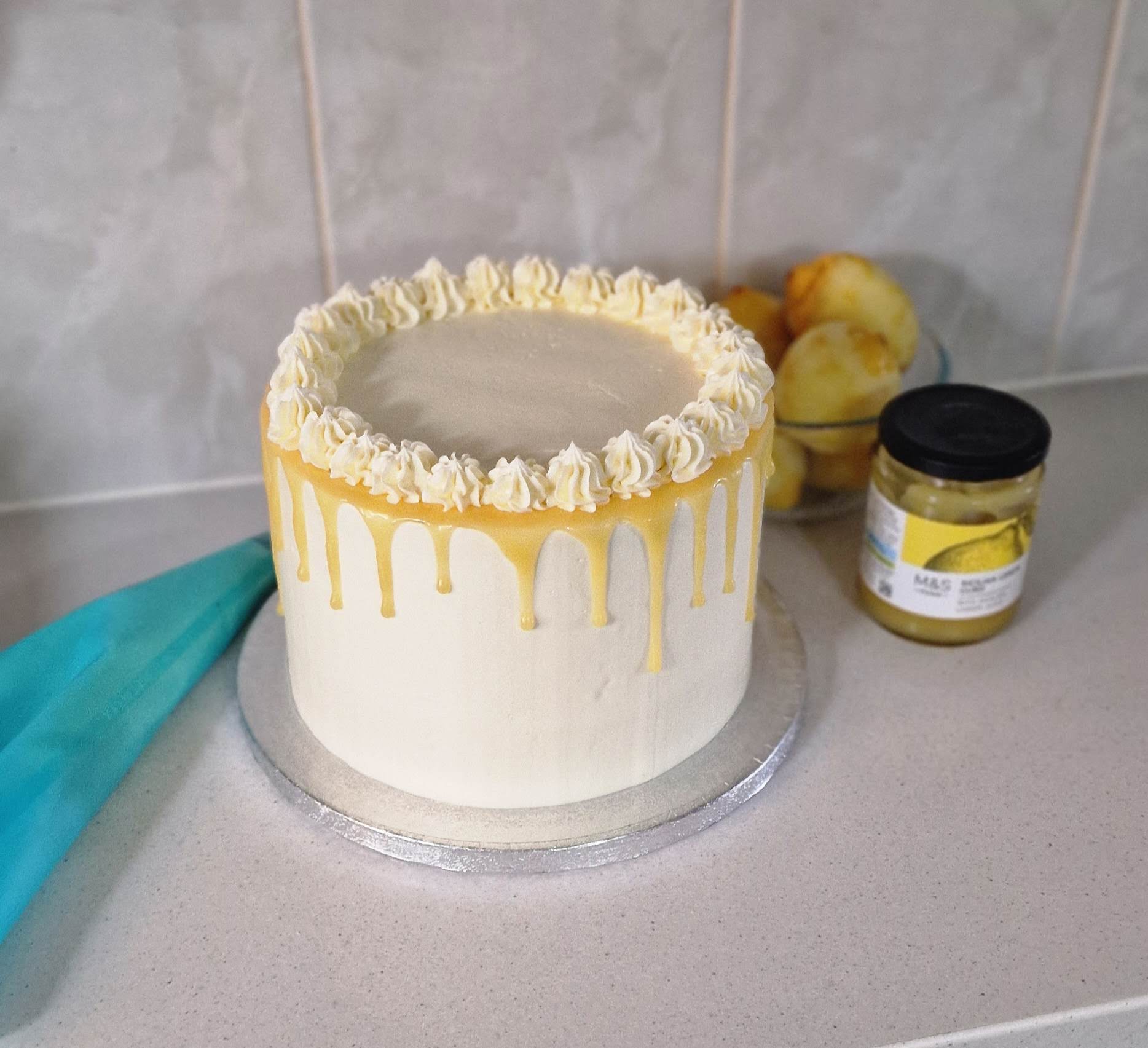 Bespoke lemon, white chocolate and lemon curd drip wedding cake setup