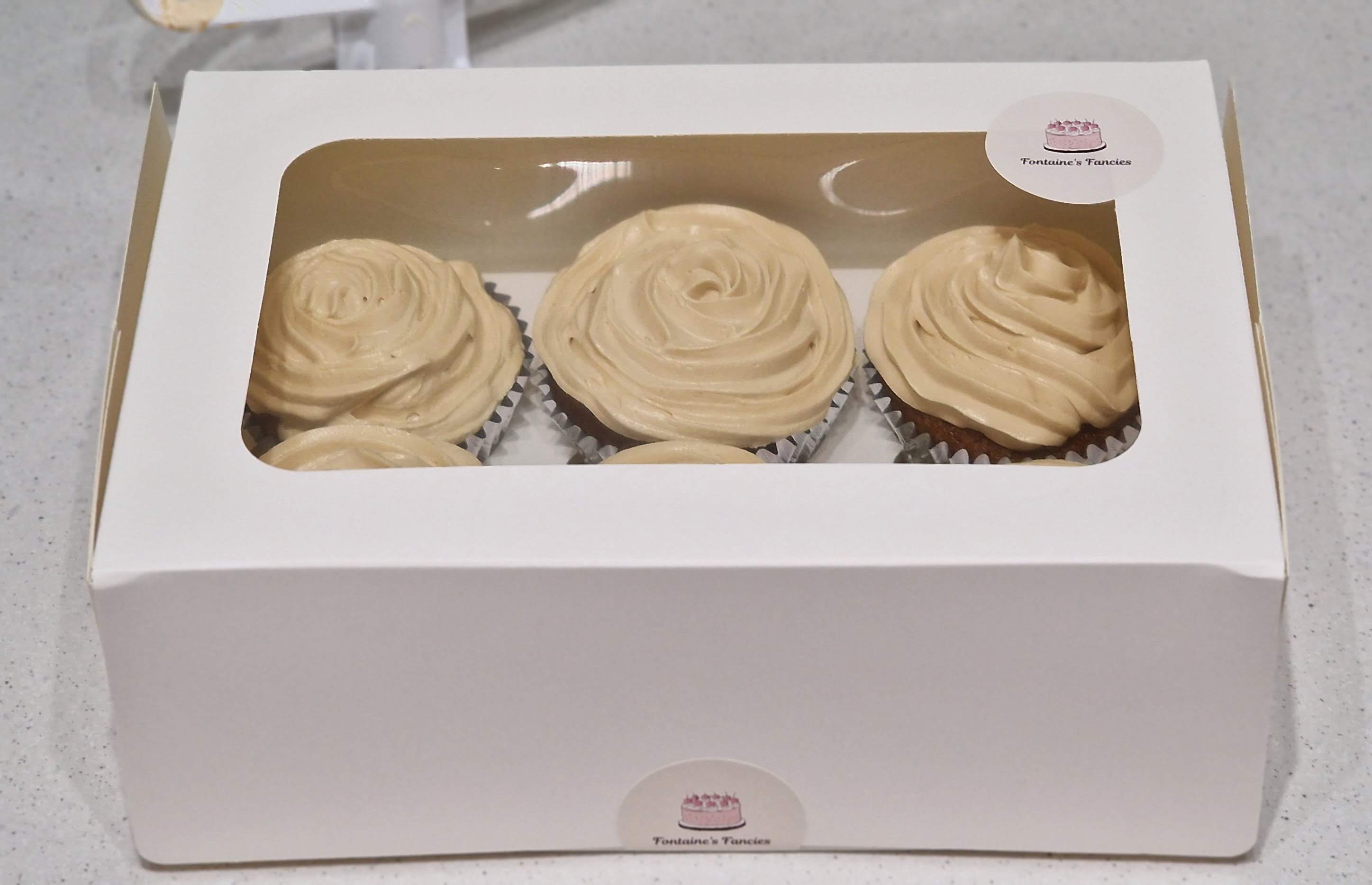 Presentation box of freshly baked Biscoff cookie spread swirl cupcakes